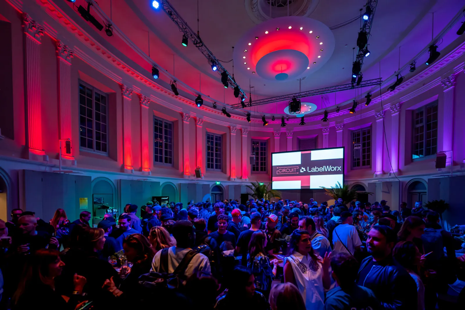 A networking room at ADE Pro, full of people talking in small groups